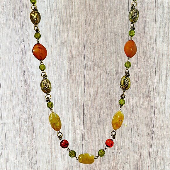 Multi color bead necklace with a mix of beige, green, and deep orange tones. - Picture 7 of 11